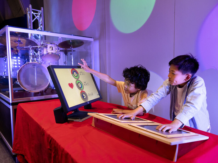 Children explore making music exhibit