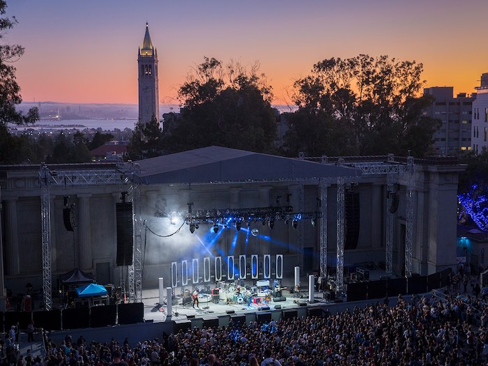 Lord Huron show at the Greek Theatre in Berkeley with fans at sunset showing the campanile