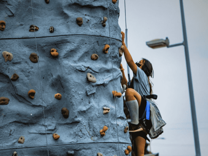 child climbs rock wall