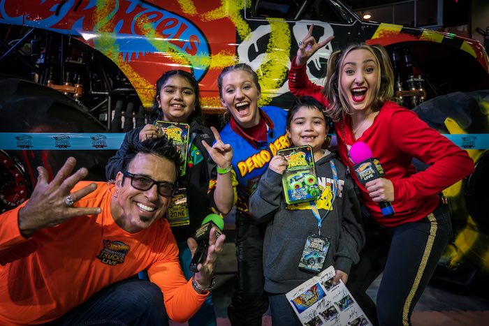 people holding hot wheels cars with huge smiles