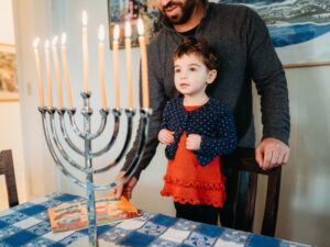 large menorah and child looks on