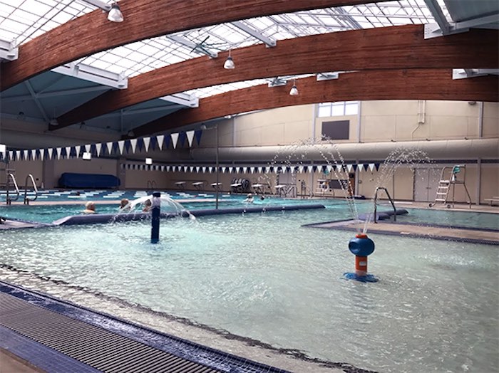 zero entry swimming pool with water spray features for toddlers