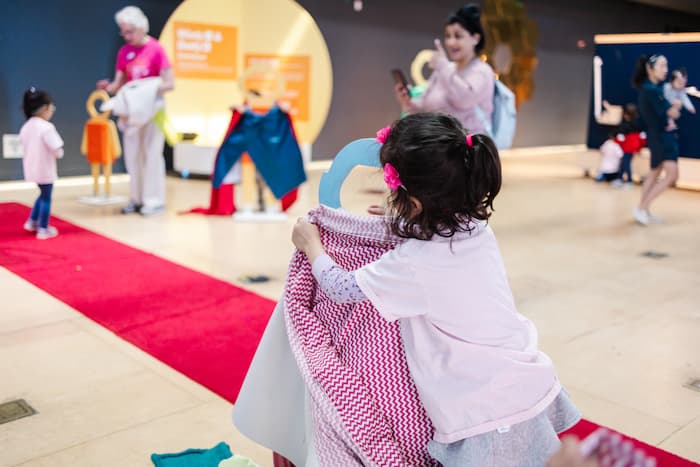 little girl building space suit with fabric
