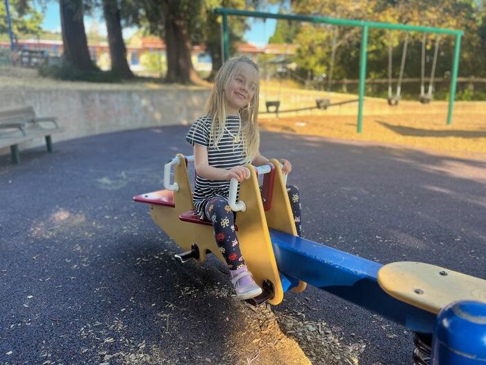 Child playing on seesaw