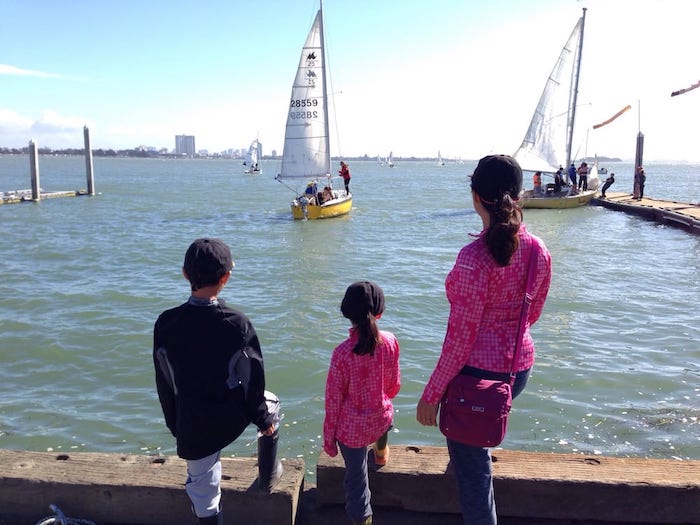 mom and 2 kids looking at the berkeley marina near cal sailing club