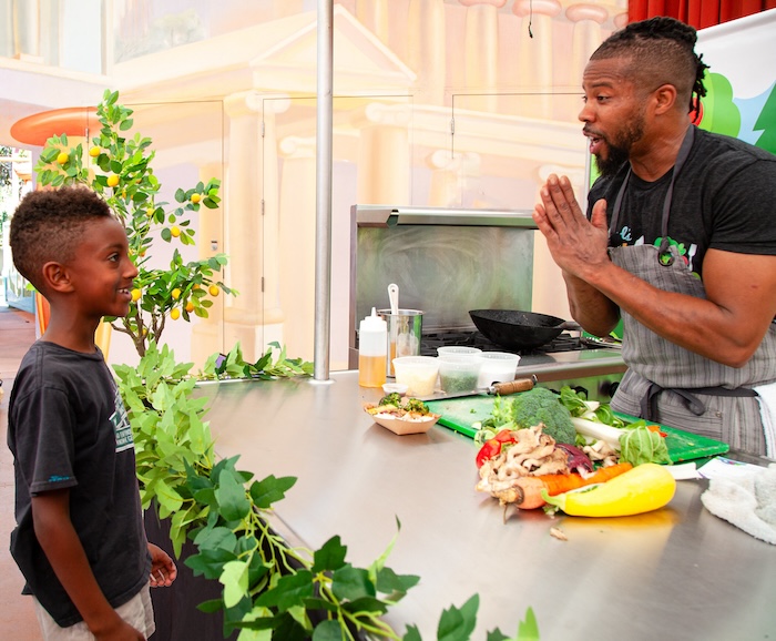 chef imani greer and a child discuss food