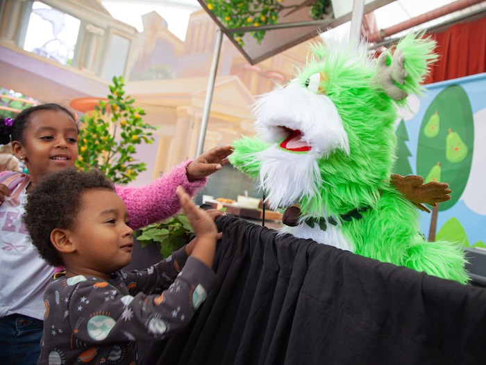 fairyland puppet quercus greets young guests after the cooking demo