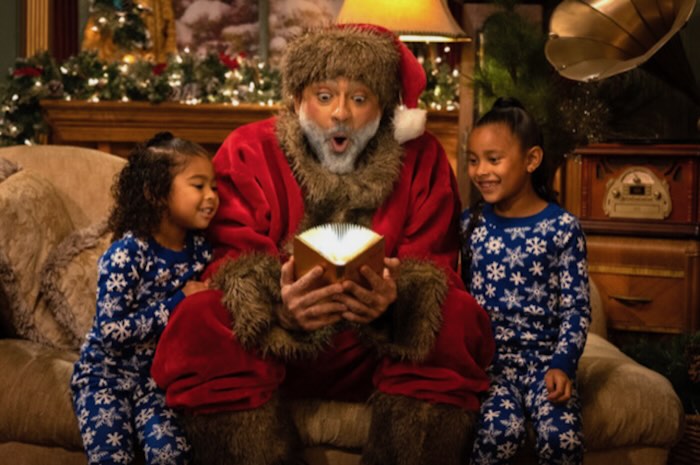 black santa with two children in a workshop setting 