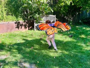 child running with butterfly wings