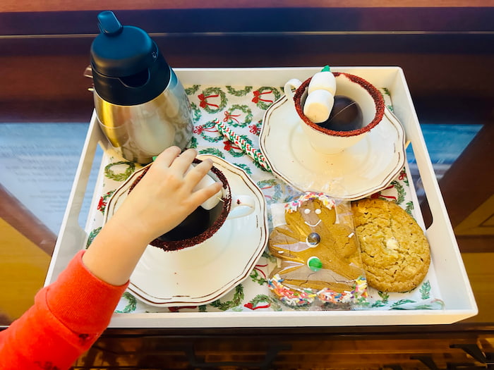 cups of hot chocolate with a child's hand