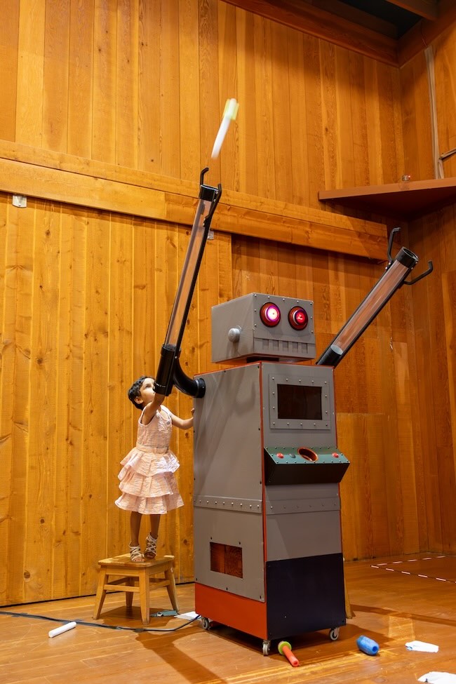 Curiodyssey exhibit with robot and little girl