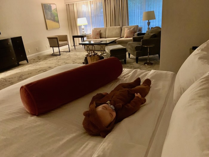 baby on a hotel room bed