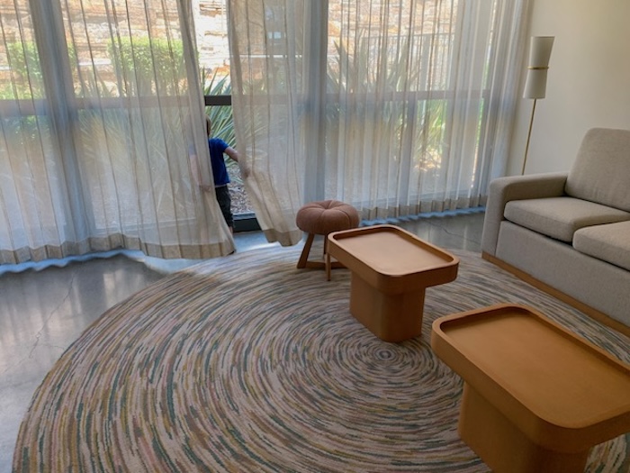 small child hiding behind a hotel room curtain