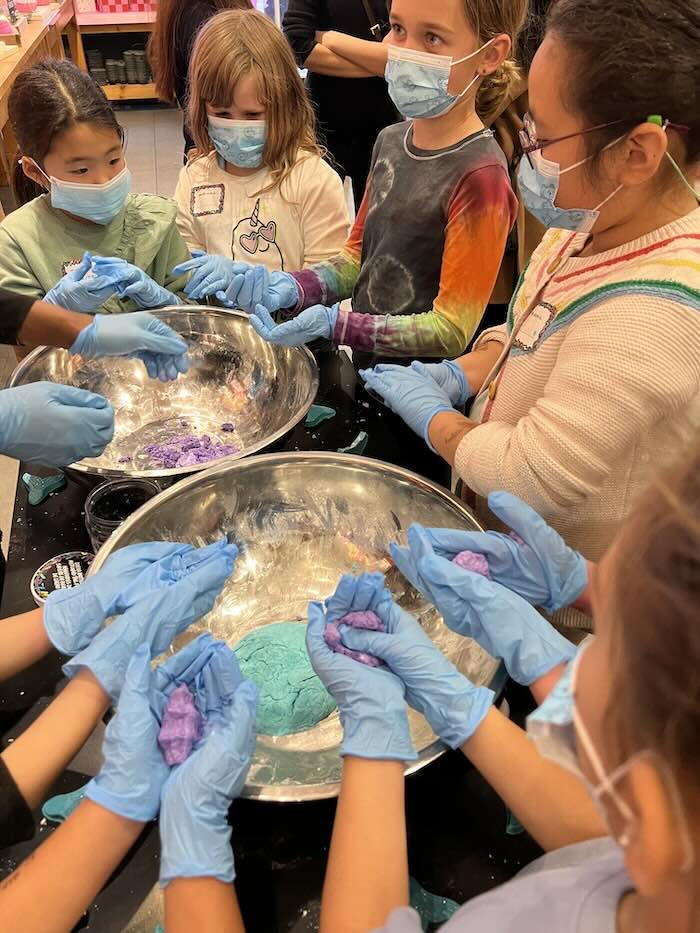 children at lush birthday party making bath bombs