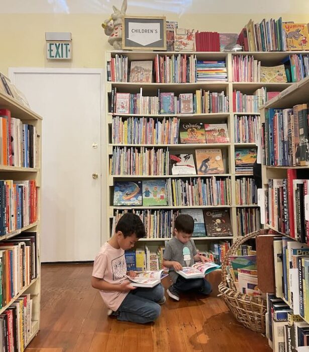 children reading on the floor of a bookstore