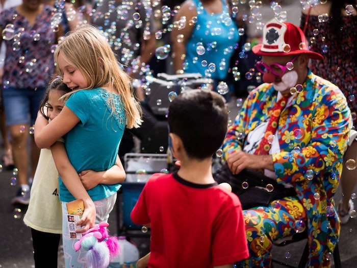 kids embrace bubbles and a clown