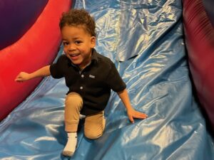 kid sliding down an inflatable slide