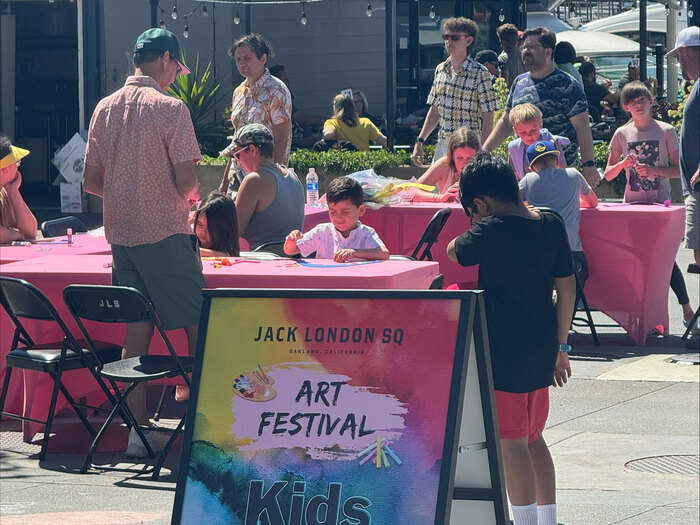 Children and parents at festival in Oakland, children making art