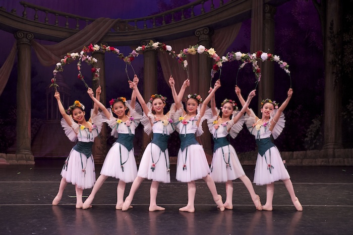 after school class guide dancers on stage with floral arches