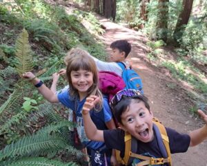 kids on a nature hike together in the woods