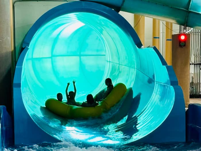 kids in a water slide tube