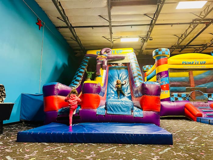 kids on giant bouncy house slide