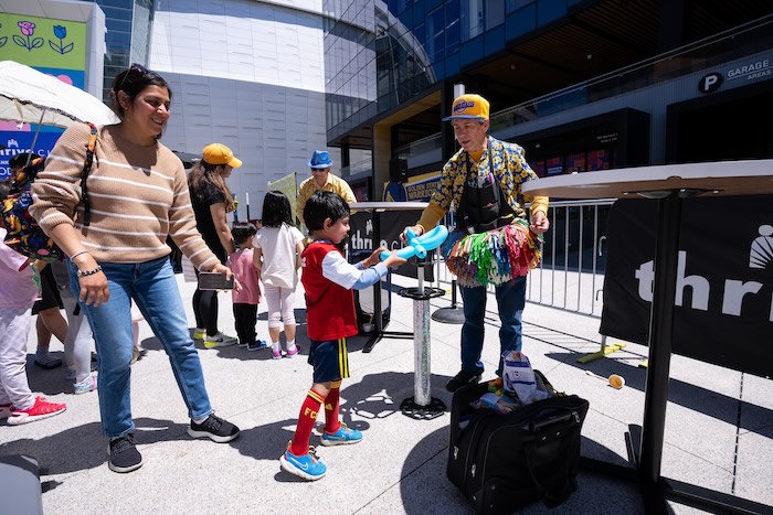child receiving balloon art at thrive city chase center warriors 