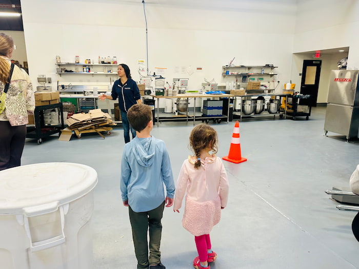 two kids walking on factory floor