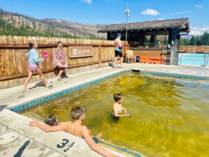kids in green mineral hot springs pool