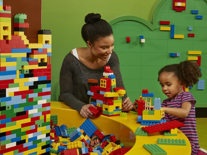 mom and child playing with lego duplo bricks