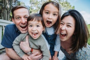 close up of family faces with two adults and two children