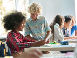 that charter school life students helping each other while working at desks