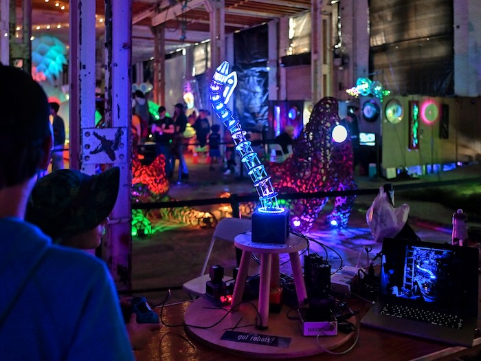 children in an illuminated room of gadgets and robots