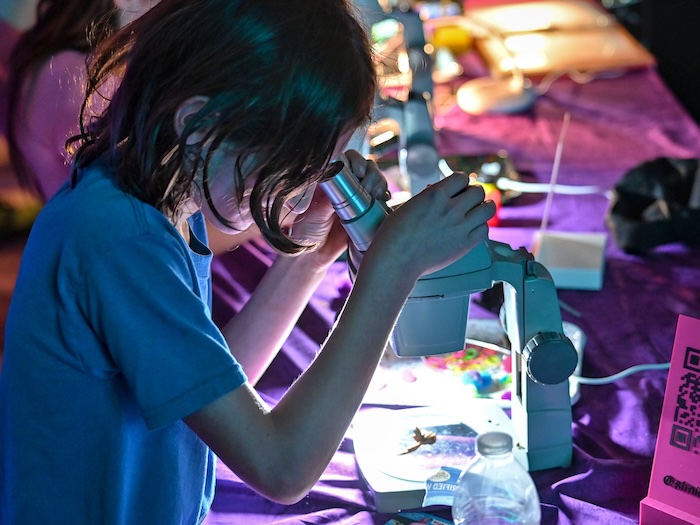 kid using a microscope