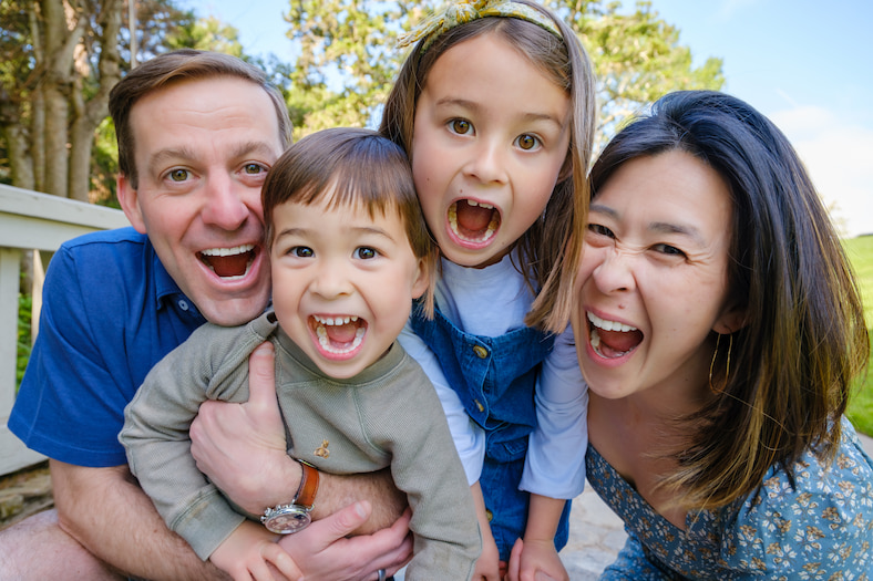 close up of family faces with two adults and two children