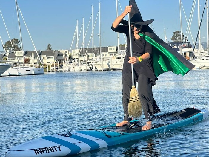 a witch on a stand up paddleboard