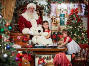 santa claus with two girls in a christmas vignette