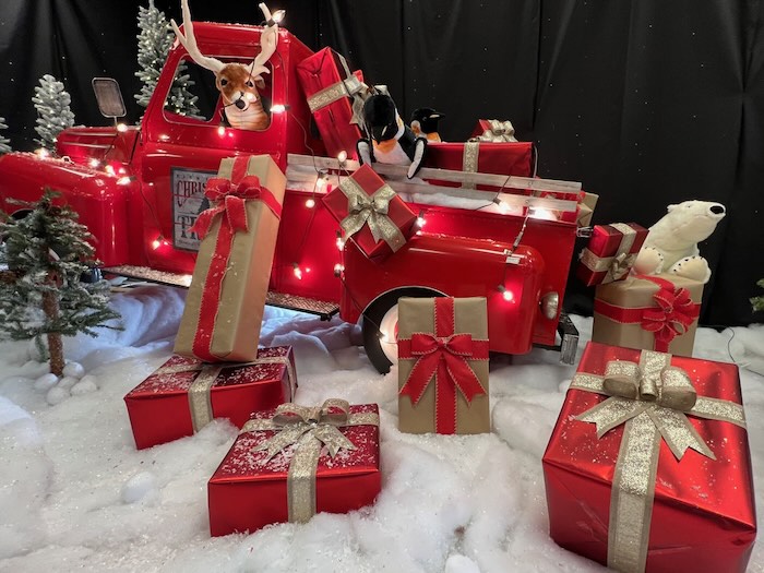 festive christmas scene as a Santa Claus photo backdrop with snow, red truck, presents, polar bear