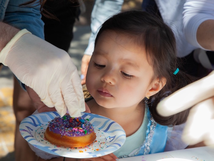 child and mochi donut up close