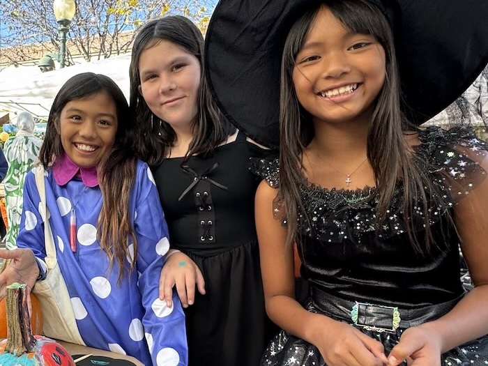 three kids in halloween costumes