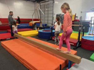 Child on gymnastics balance beam