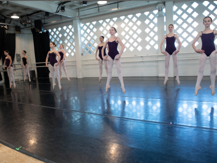 teens in dance class leaping