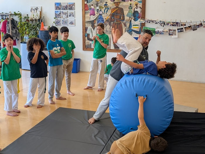 learning to fly using a giant cylinder United Capoeira Association - Hayward