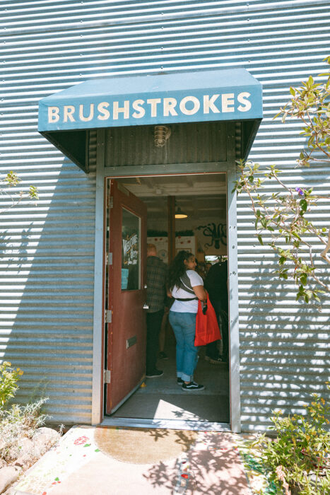 brushstrokes studio opening doorway. welcome in. come when you like baby's day out may 2025. photo by laura jaeger