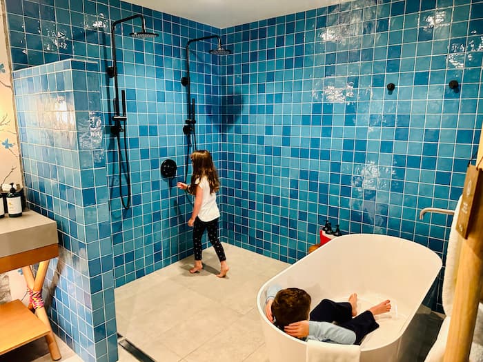 kids playing in large blue shower
