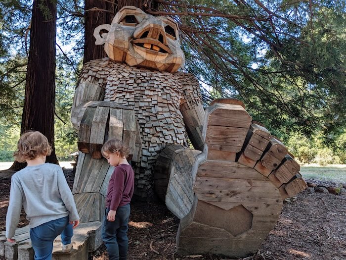 giant sitting troll and cutie pie twins exploring