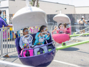 two cute kids on a carnival ride with face paint on