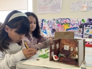 two girls art materials and a small diorama