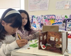 two girls art materials and a small diorama