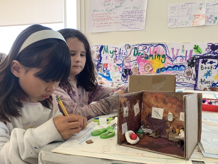 two girls art materials and a small diorama